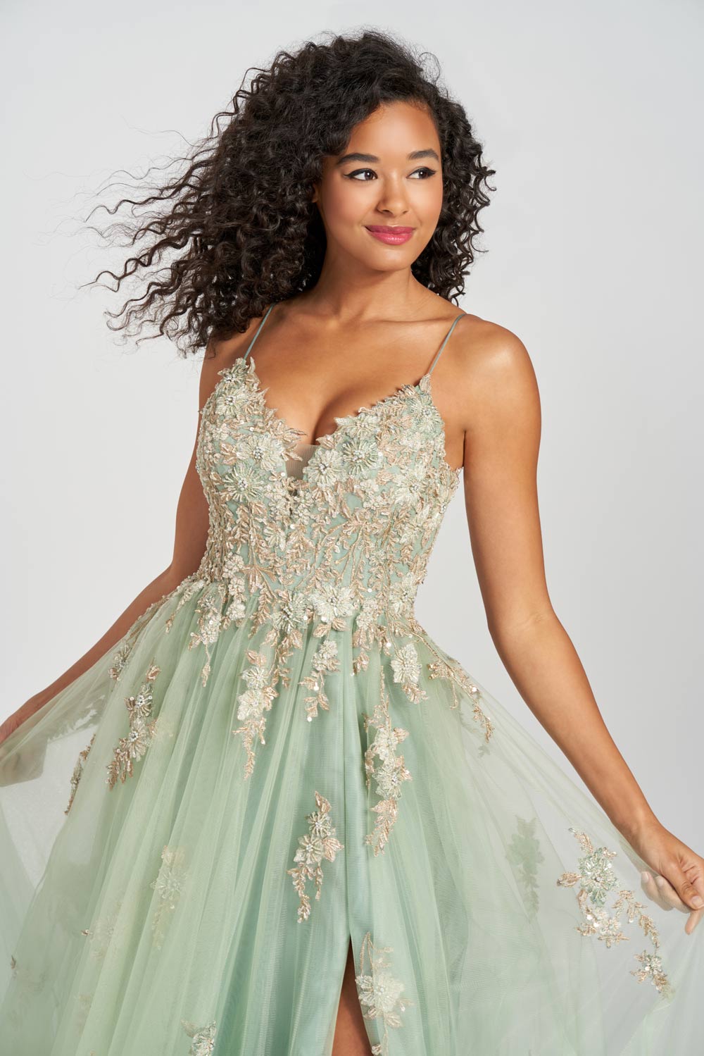 photo is a close up. Black curly haired model showing detail of the ivy prom dress.